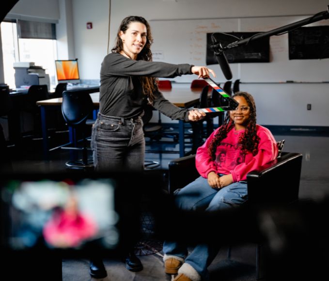 Woman Being Prepped By Producer For On Screen Interview