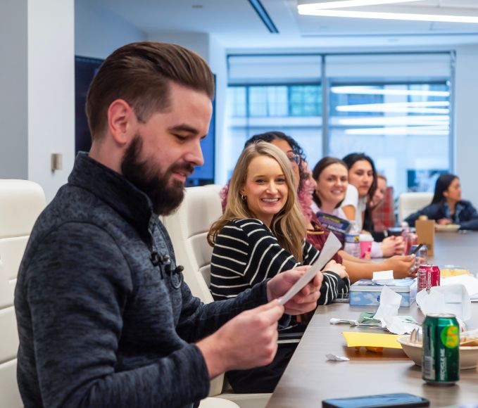 Man At Conference Table Opening Gifts