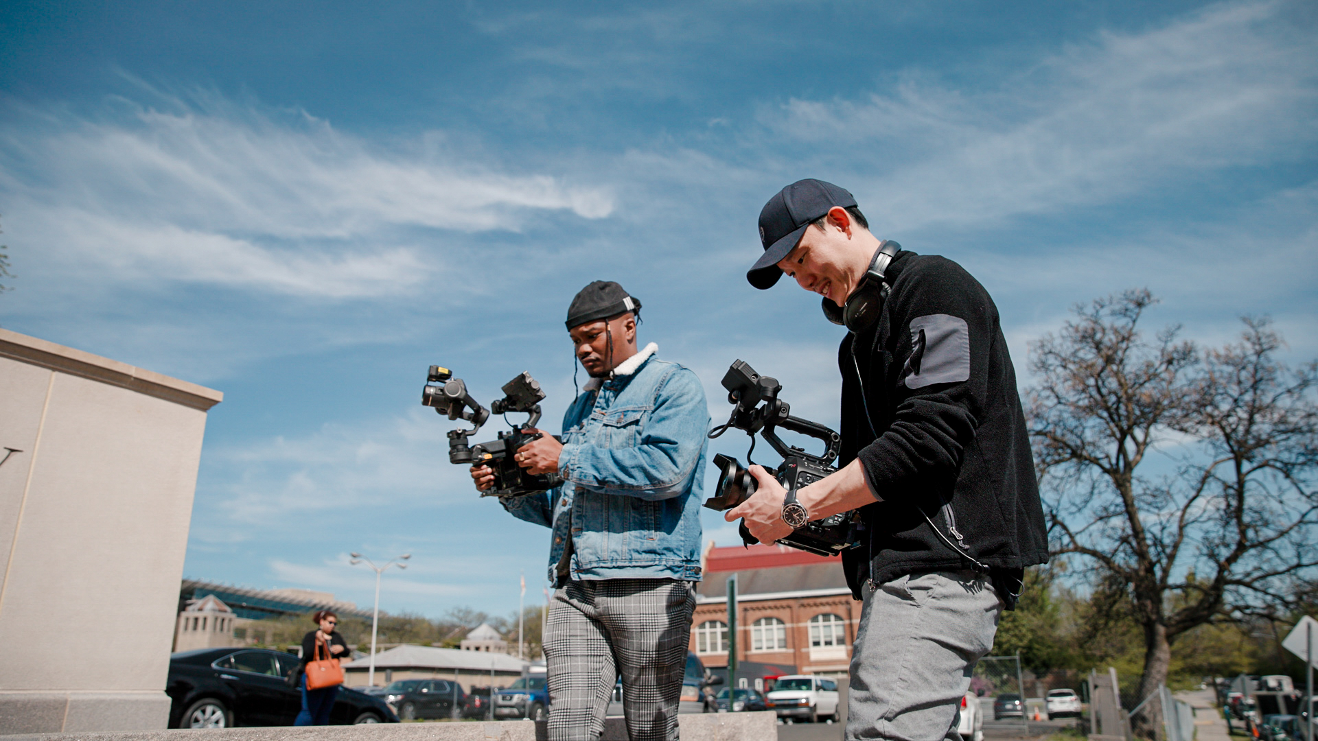 Two Camera Operators Using Handheld Cameras